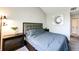 Bedroom featuring neutral walls, carpet flooring and a contemporary furniture set with unique art at 8500 E Jefferson Ave # 19B, Denver, CO 80237