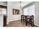 Cozy dining area featuring wood floors, a modern light fixture, and artwork at 8500 E Jefferson Ave # 19B, Denver, CO 80237