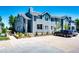 Multi-level townhouse complex with blue siding, reserved parking spots and well maintained landscaping at 8500 E Jefferson Ave # 19B, Denver, CO 80237