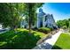 Multi-level townhouse complex with blue siding, green landscaping and sidewalk leading to the units at 8500 E Jefferson Ave # 19B, Denver, CO 80237