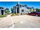 Exterior view of the condominium building with reserved parking spaces and lush landscaping at 8500 E Jefferson Ave # 19B, Denver, CO 80237
