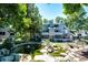 Exterior view of a modern condominium building with well-manicured landscaping including a pond at 8500 E Jefferson Ave # 19B, Denver, CO 80237