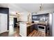 Modern kitchen featuring stainless steel appliances and dark cabinetry at 8500 E Jefferson Ave # 19B, Denver, CO 80237