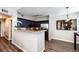 Open layout of kitchen with bar and adjacent dining area with wood-style flooring at 8500 E Jefferson Ave # 19B, Denver, CO 80237