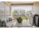 Relaxing back porch area with comfortable seating, grill, and view of the backyard at 8844 S Sicily Ct, Aurora, CO 80016