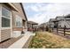 Spacious backyard with a patio area, green lawn, and a wood fence at 8844 S Sicily Ct, Aurora, CO 80016
