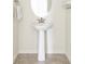 Modern powder room featuring a pedestal sink and tiled flooring at 8844 S Sicily Ct, Aurora, CO 80016