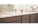 Bathroom vanity with granite countertops, stylish decor, and dark wood cabinets at 8844 S Sicily Ct, Aurora, CO 80016