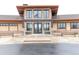 Clubhouse exterior featuring large windows, stone accents, and inviting entrance with benches at 8844 S Sicily Ct, Aurora, CO 80016