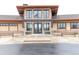 The building featuring beautiful stone and steel accents, accessible by the sidewalk from the parking area at 8844 S Sicily Ct, Aurora, CO 80016