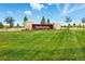 Community entrance showcasing an attractive 'Inspiration' sign, beautiful landscaping, and a well-manicured lawn at 8844 S Sicily Ct, Aurora, CO 80016