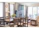 Open-concept living and dining area with a modern fireplace, large windows, and stylish decor at 8844 S Sicily Ct, Aurora, CO 80016