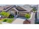 Charming home featuring a two-car garage, stone accents, and well-manicured front lawn at 8844 S Sicily Ct, Aurora, CO 80016