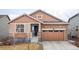 Charming single-Gathering home featuring a brick facade, two-car garage, and manicured lawn at 8844 S Sicily Ct, Aurora, CO 80016