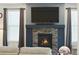 Contemporary fireplace with a dark mantel, modern tile, and a wall-mounted television at 8844 S Sicily Ct, Aurora, CO 80016