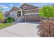 Charming two-story home featuring a stone facade, two-car garage, and well-maintained landscaping at 8844 S Sicily Ct, Aurora, CO 80016