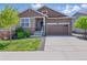 Charming two-story home featuring a stone facade, two-car garage, and well-maintained landscaping at 8844 S Sicily Ct, Aurora, CO 80016
