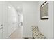 Hallway featuring tiled floors, a cushioned bench, wall art, and access to other rooms at 8844 S Sicily Ct, Aurora, CO 80016