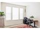 Bright home office featuring three large windows and a wood-look floor with an oriental rug at 8844 S Sicily Ct, Aurora, CO 80016