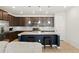 Spacious kitchen with granite island, stainless steel appliances, dark cabinets, and wood flooring at 8844 S Sicily Ct, Aurora, CO 80016