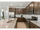 Modern kitchen features stainless steel appliances, granite counters, and plenty of cabinet space at 8844 S Sicily Ct, Aurora, CO 80016
