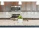 The kitchen features stainless steel appliances, granite counters, and a subway tile backsplash at 8844 S Sicily Ct, Aurora, CO 80016