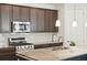 Modern kitchen with stainless steel appliances, granite counters, and a center island with a breakfast bar at 8844 S Sicily Ct, Aurora, CO 80016