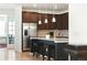 Modern kitchen features stainless steel appliances, granite counters, and a center island with breakfast bar at 8844 S Sicily Ct, Aurora, CO 80016