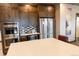 Contemporary kitchen features stainless steel appliances, a center island, and ample cabinet space at 8844 S Sicily Ct, Aurora, CO 80016