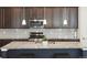 A spacious kitchen with stainless steel appliances, granite counters, and a center island with breakfast bar at 8844 S Sicily Ct, Aurora, CO 80016
