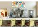 Modern kitchenette with sleek countertops, stylish backsplash, and comfortable seating at 8844 S Sicily Ct, Aurora, CO 80016