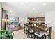 The open-concept living and dining area features wood floors, a fireplace, and access to the backyard at 8844 S Sicily Ct, Aurora, CO 80016