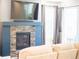 Cozy living room featuring a modern fireplace with tile surround and large windows with natural light at 8844 S Sicily Ct, Aurora, CO 80016