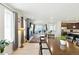 The spacious living room and kitchen offer an open floor plan, wood floors, and plenty of natural light at 8844 S Sicily Ct, Aurora, CO 80016