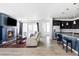 Spacious open-concept living space with a fireplace, modern kitchen with island, and wood flooring at 8844 S Sicily Ct, Aurora, CO 80016