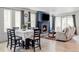 Open-concept living and dining area with a modern fireplace, large windows, and stylish decor at 8844 S Sicily Ct, Aurora, CO 80016