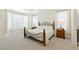 Spacious main bedroom with tray ceiling, plush carpeting, and generous natural light from large windows at 8844 S Sicily Ct, Aurora, CO 80016