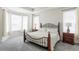 Comfortable primary bedroom with a decorative metal bed frame and natural light at 8844 S Sicily Ct, Aurora, CO 80016