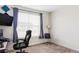 Home office featuring two rolling chairs with natural light and dark curtains at 8844 S Sicily Ct, Aurora, CO 80016