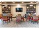 Cozy reading room featuring comfortable chairs, tables, and well-stocked bookshelves at 8844 S Sicily Ct, Aurora, CO 80016