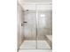 Modern walk-in shower featuring a tiled surround, built-in bench, and glass enclosure at 8844 S Sicily Ct, Aurora, CO 80016