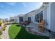 Lush backyard features a paved patio with outdoor seating and an artificial turf area at 367 Josef Cir, Fort Lupton, CO 80621