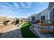 Backyard oasis with turf, stone, and a seating area perfect for outdoor entertaining at 367 Josef Cir, Fort Lupton, CO 80621