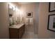 Modern bathroom featuring a sleek vanity, decorative mirror, and stylish lighting at 367 Josef Cir, Fort Lupton, CO 80621