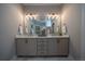 Elegant bathroom with double vanity, quartz countertops, and designer light fixtures at 367 Josef Cir, Fort Lupton, CO 80621