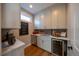 Butler's pantry featuring a sink, beverage fridge, and ample cabinet storage space at 367 Josef Cir, Fort Lupton, CO 80621