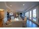 Open floor plan with a dining area, fireplace, and access to the outdoor living space at 367 Josef Cir, Fort Lupton, CO 80621