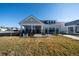 Charming single-story home with a covered porch and black metal fence on a sunny day at 367 Josef Cir, Fort Lupton, CO 80621