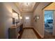 Elegant foyer with tray ceiling, wood floors, and a view into the bedroom at 367 Josef Cir, Fort Lupton, CO 80621