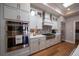 Modern kitchen boasts stainless steel appliances, white cabinets, and a stylish backsplash at 367 Josef Cir, Fort Lupton, CO 80621